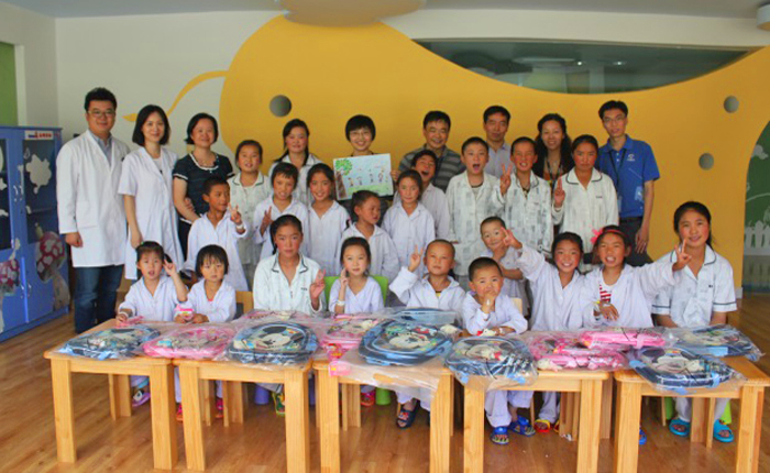 Group of volunteers with children receiving surgery